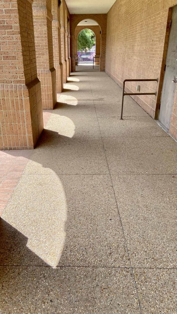 Shadows in an exterior brick hallway